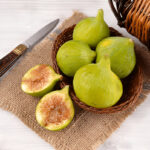 Byadi figs in basket with one cut open showing sweet honey-like flesh.