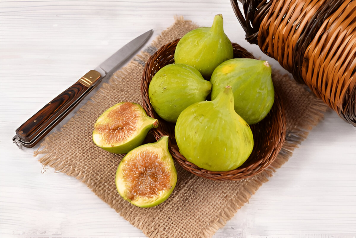 Byadi figs in basket with one cut open showing sweet honey-like flesh.